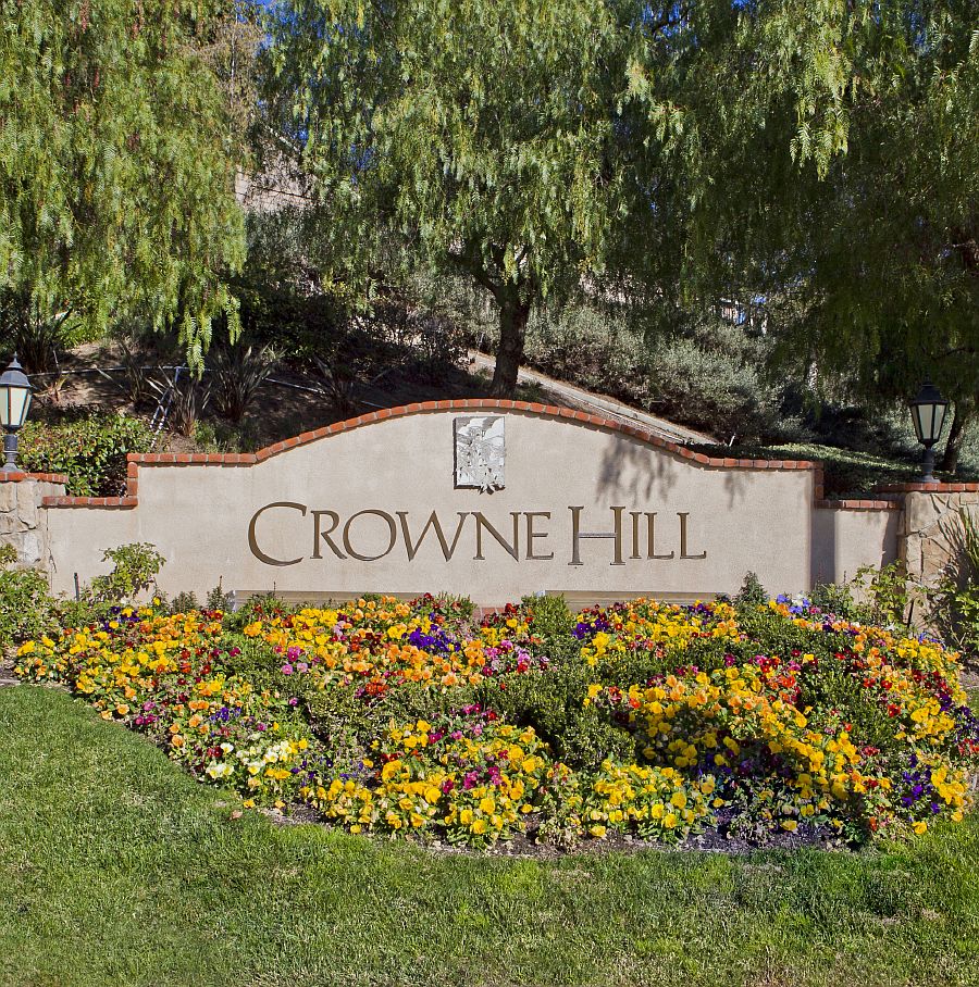 Crowne Hill entrance sign with colorful flower beds in Temecula