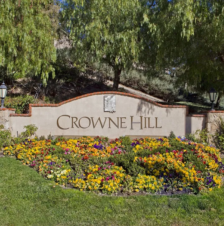 Crowne Hill entrance sign with colorful flower beds in Temecula